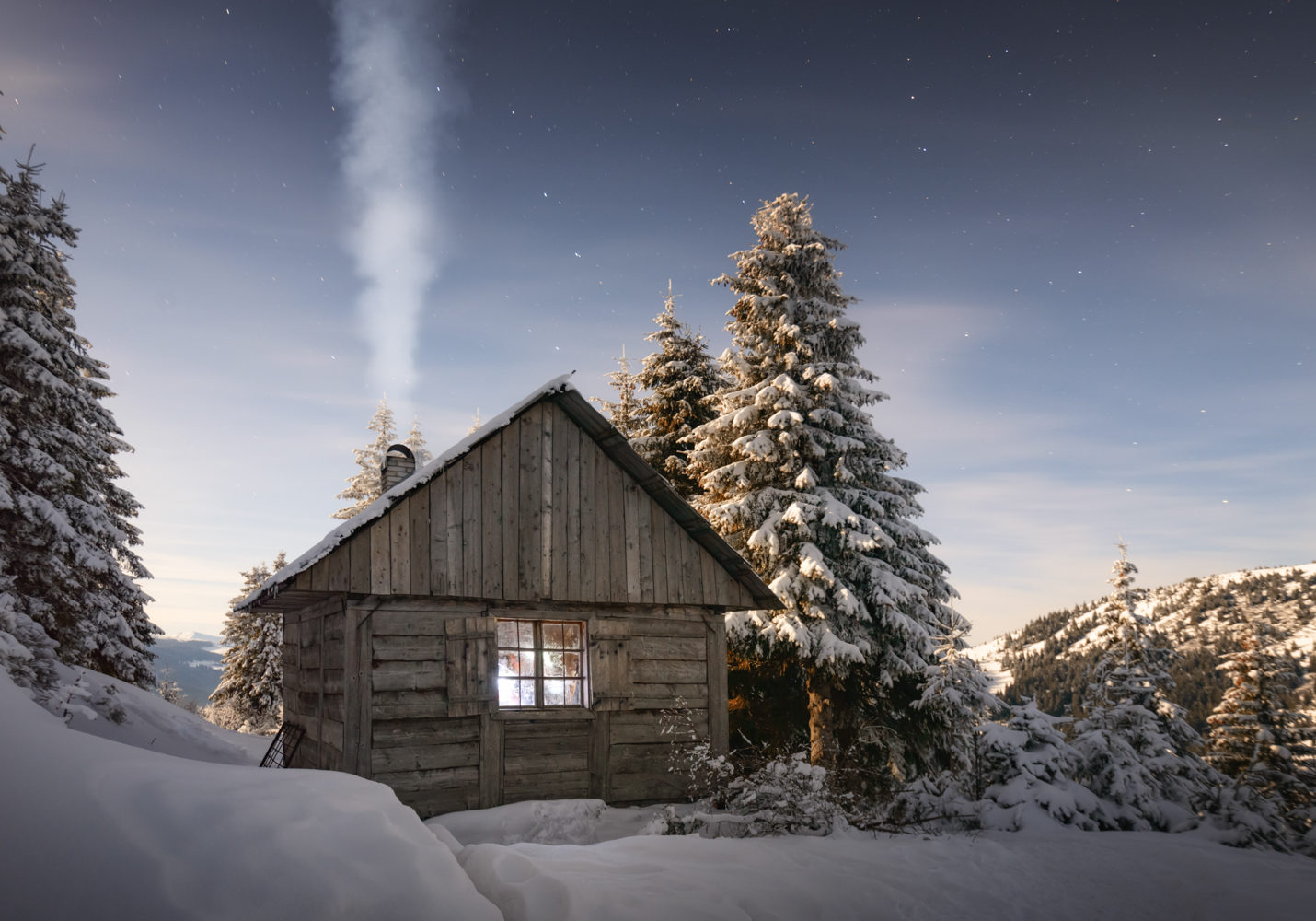 Fantastic winter landscape with wooden house in the country 